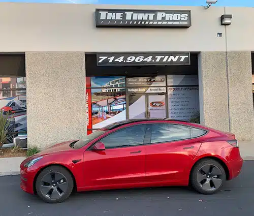 Red Tesla Model 3 with ceramic window tinting by The Tint Pros in Orange County